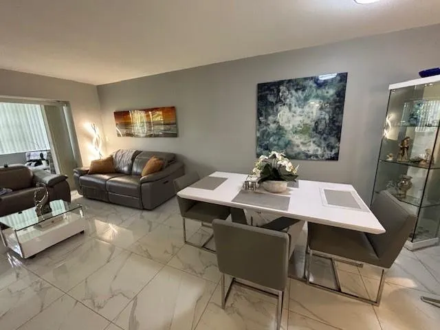 a living room with furniture a table and a window