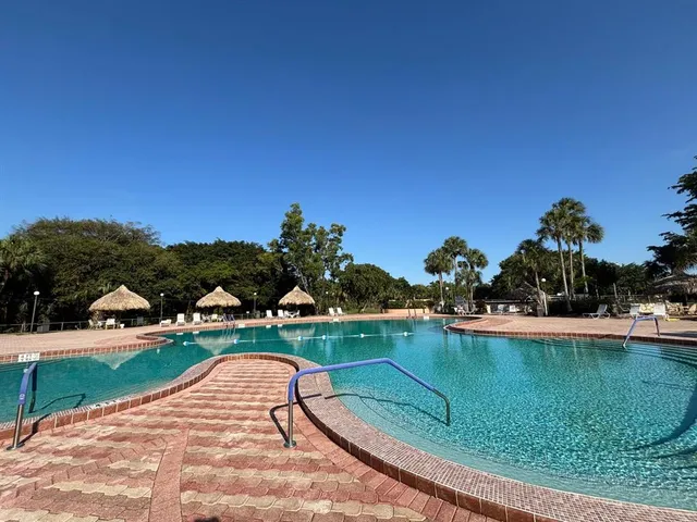 a view of a swimming pool and lounge chair