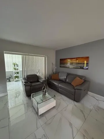 a living room with furniture and a piano