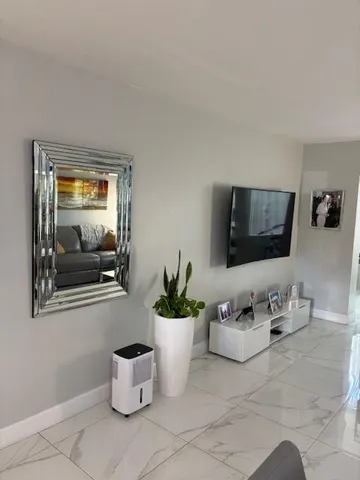 a dining room with furniture and flat screen tv