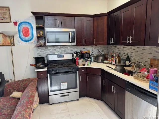 a kitchen with stainless steel appliances granite countertop a stove and cabinets