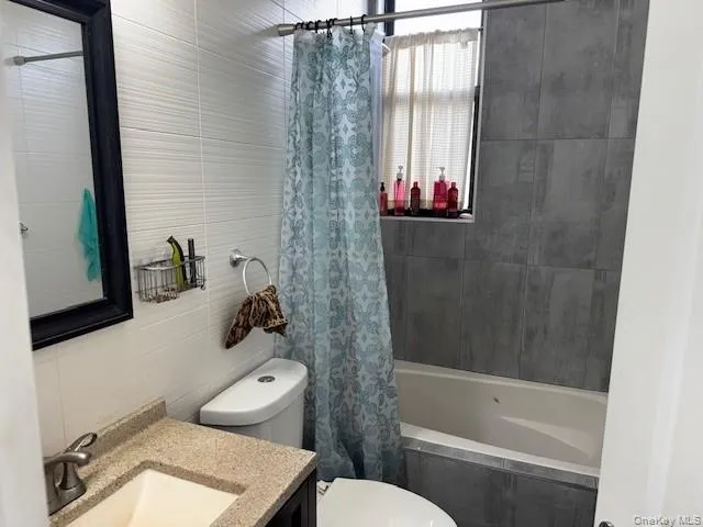 a white toilet sitting next to a bath tub