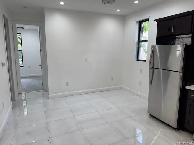 a kitchen with stainless steel appliances granite countertop a refrigerator and a stove top oven