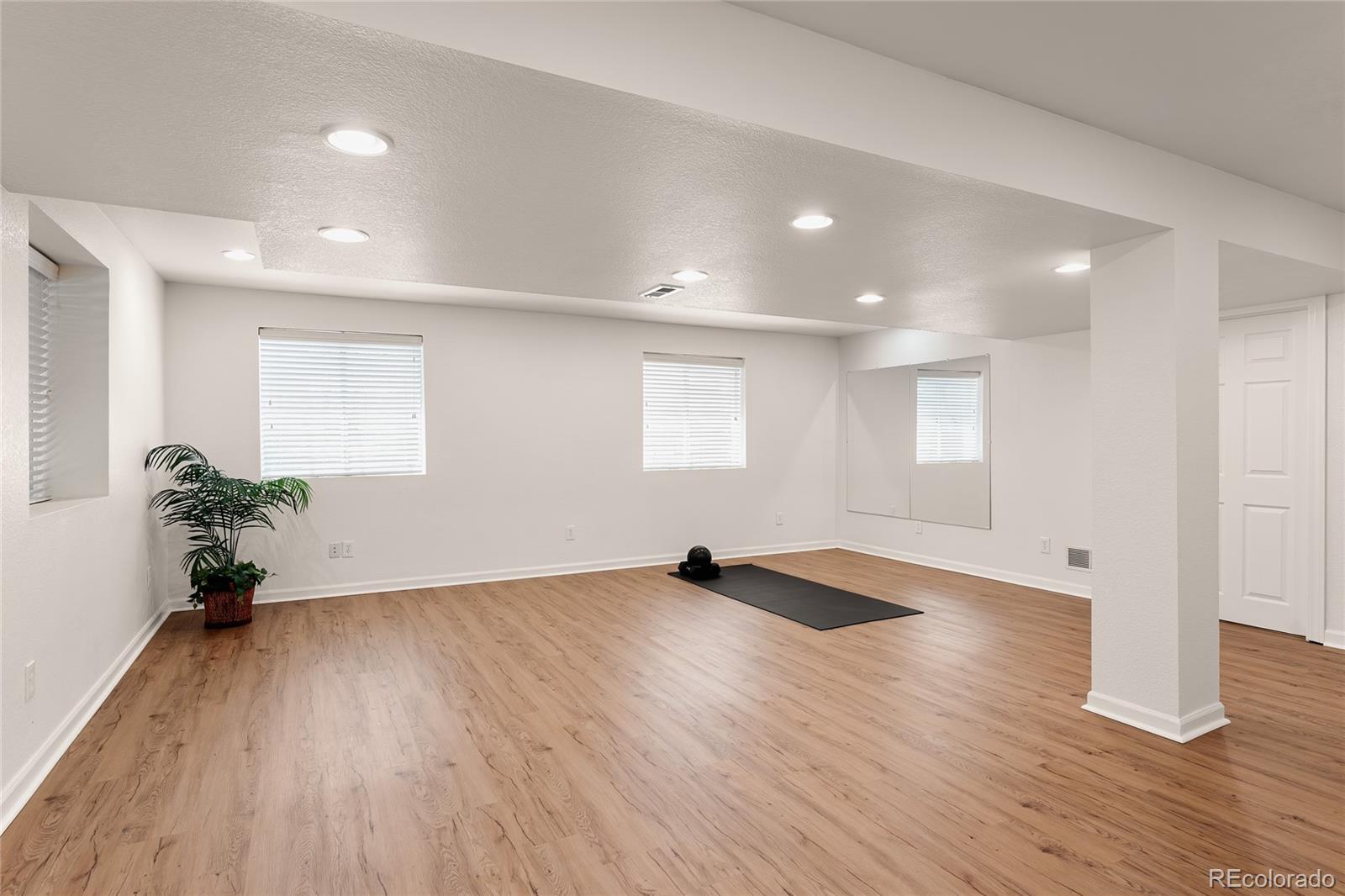 9441 South Hackberry Lane Highlands Ranch, CO 80129 - Photo 39 of 50 a view of an empty room with wooden floor and a window