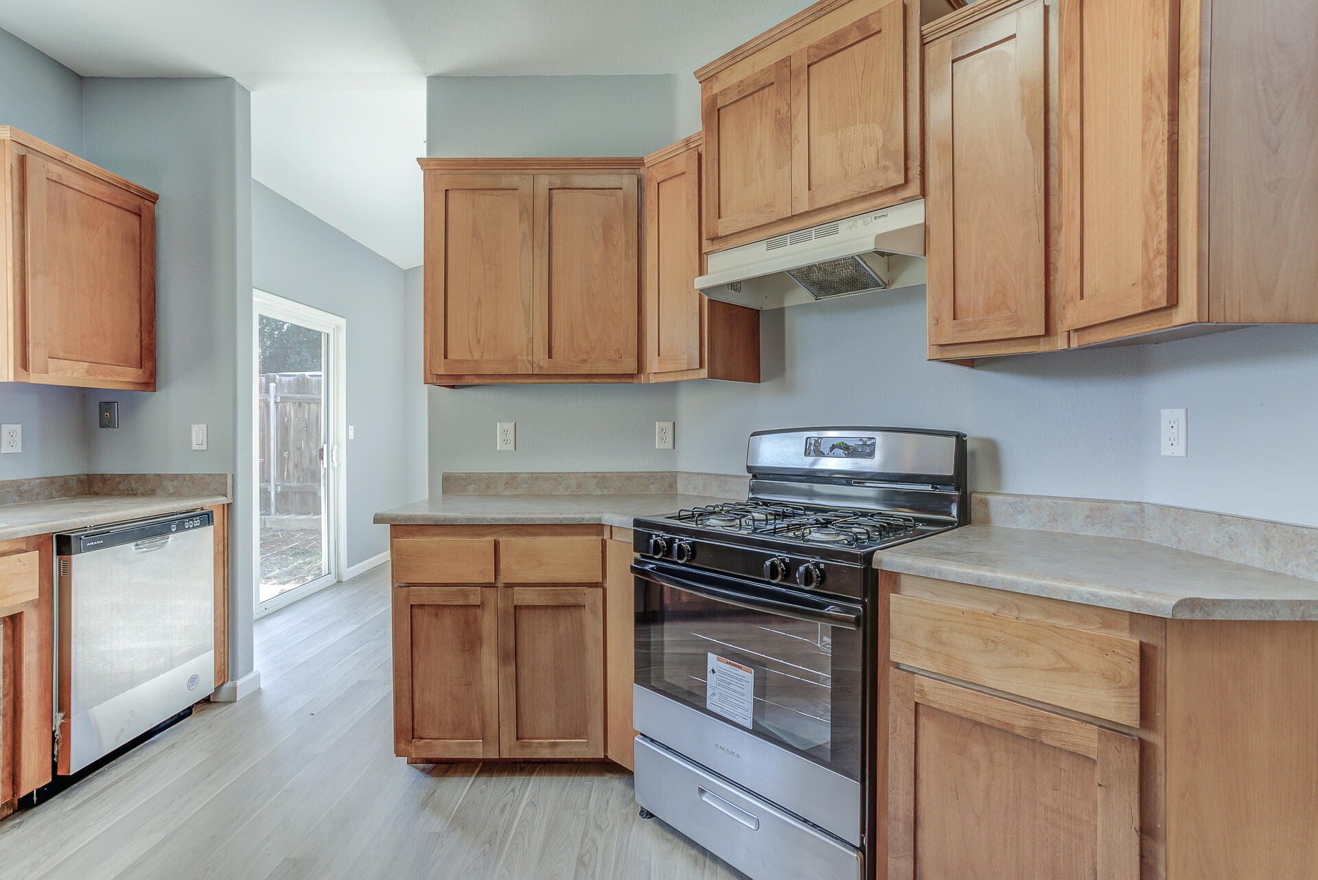 1101 Layton Road Redding, CA 96002 - Photo 12 of 37 a kitchen with stainless steel appliances granite countertop a stove a sink and a microwave
