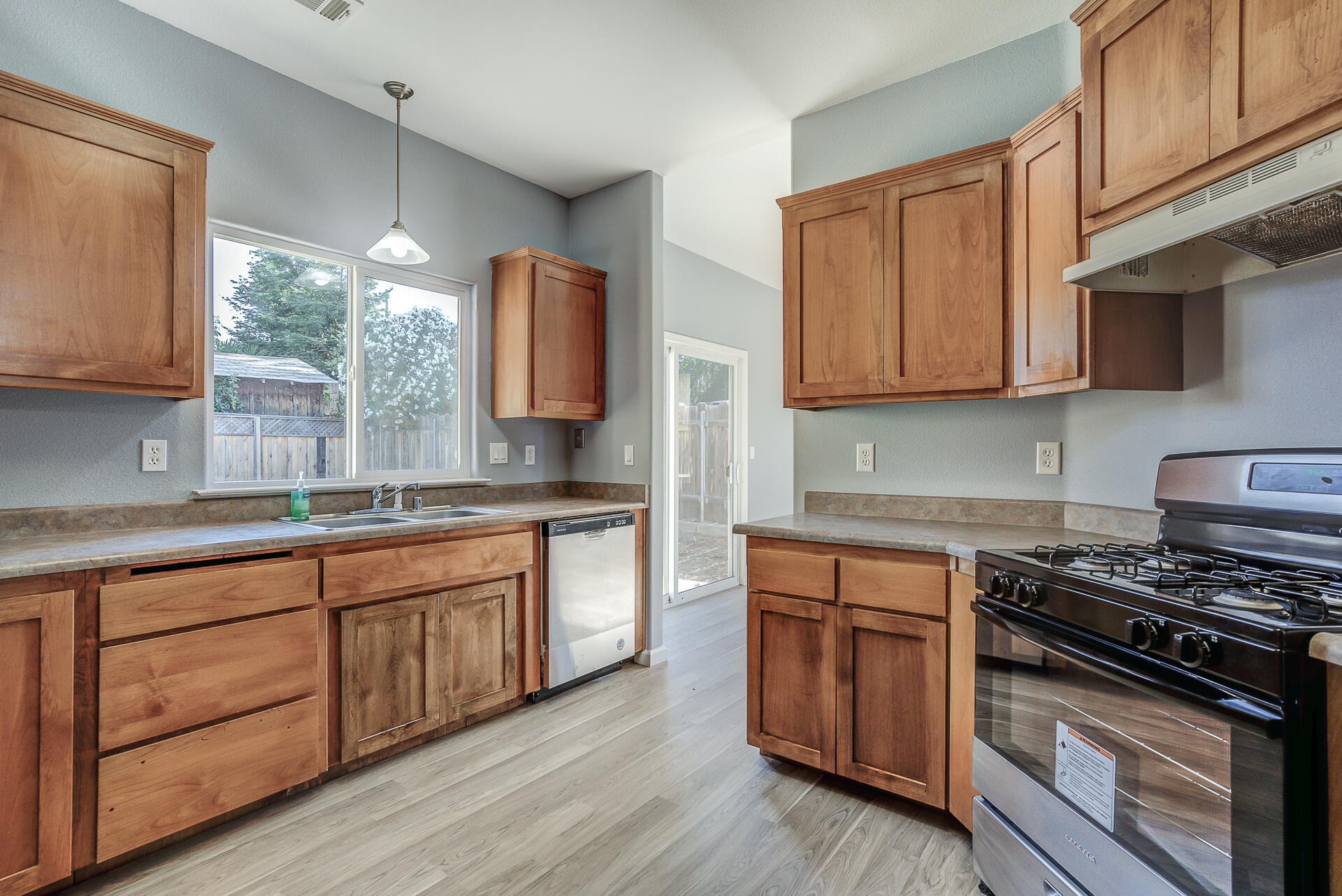 1101 Layton Road Redding, CA 96002 - Photo 13 of 37 a kitchen with wooden cabinets and a stove top oven