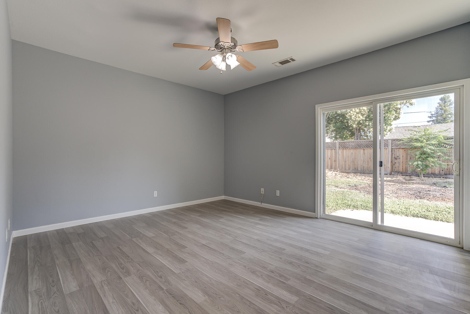 1101 Layton Road Redding, CA 96002 - Photo 17 of 37 a view of an empty room with wooden floor and a window