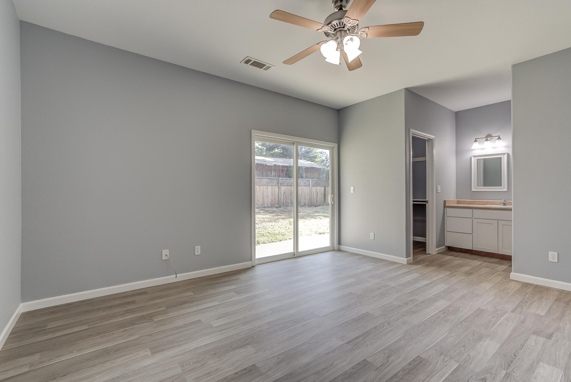1101 Layton Road Redding, CA 96002 - Photo 18 of 37 a view of an empty room with a window and wooden floor