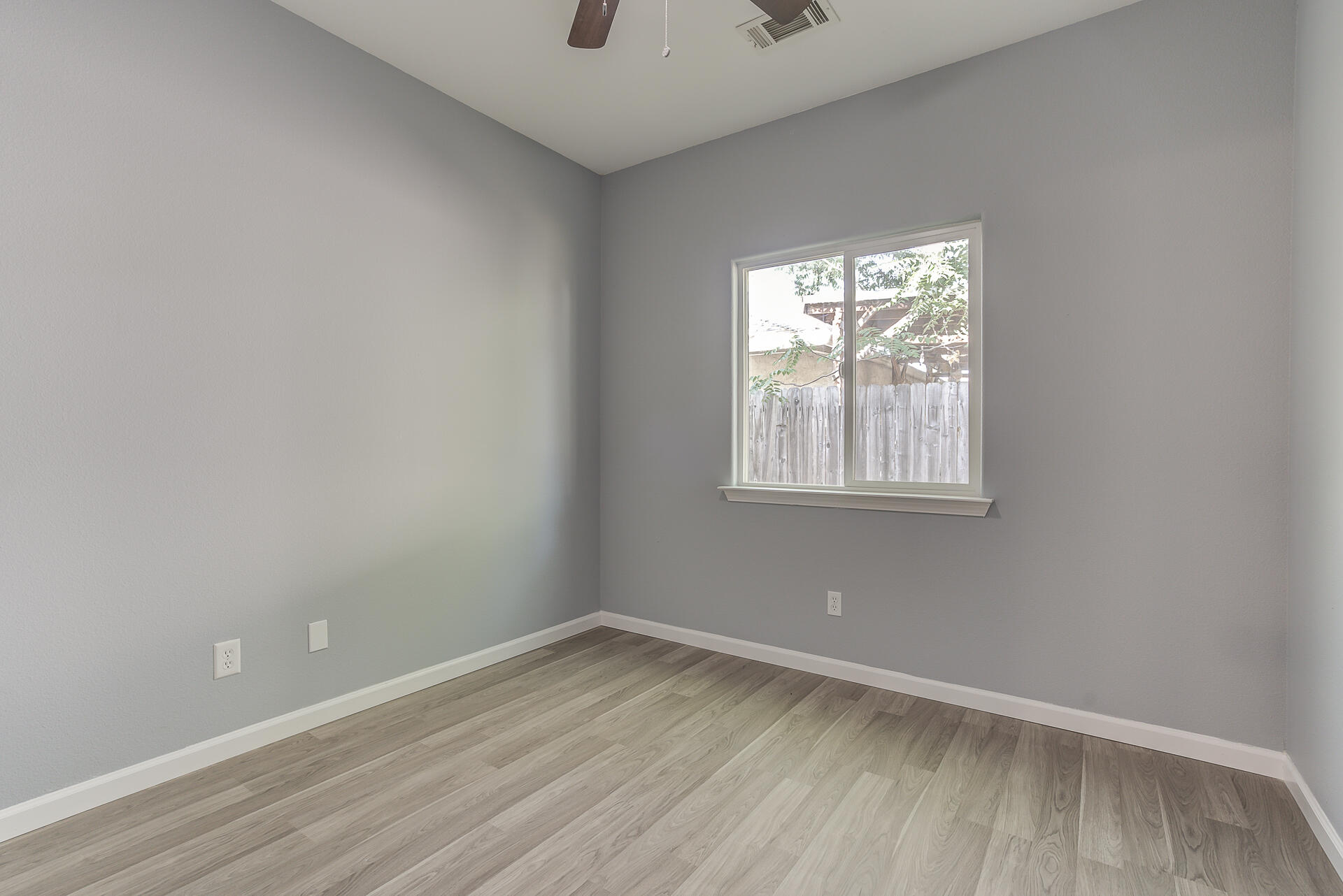 1101 Layton Road Redding, CA 96002 - Photo 22 of 37 an empty room with wooden floor and windows