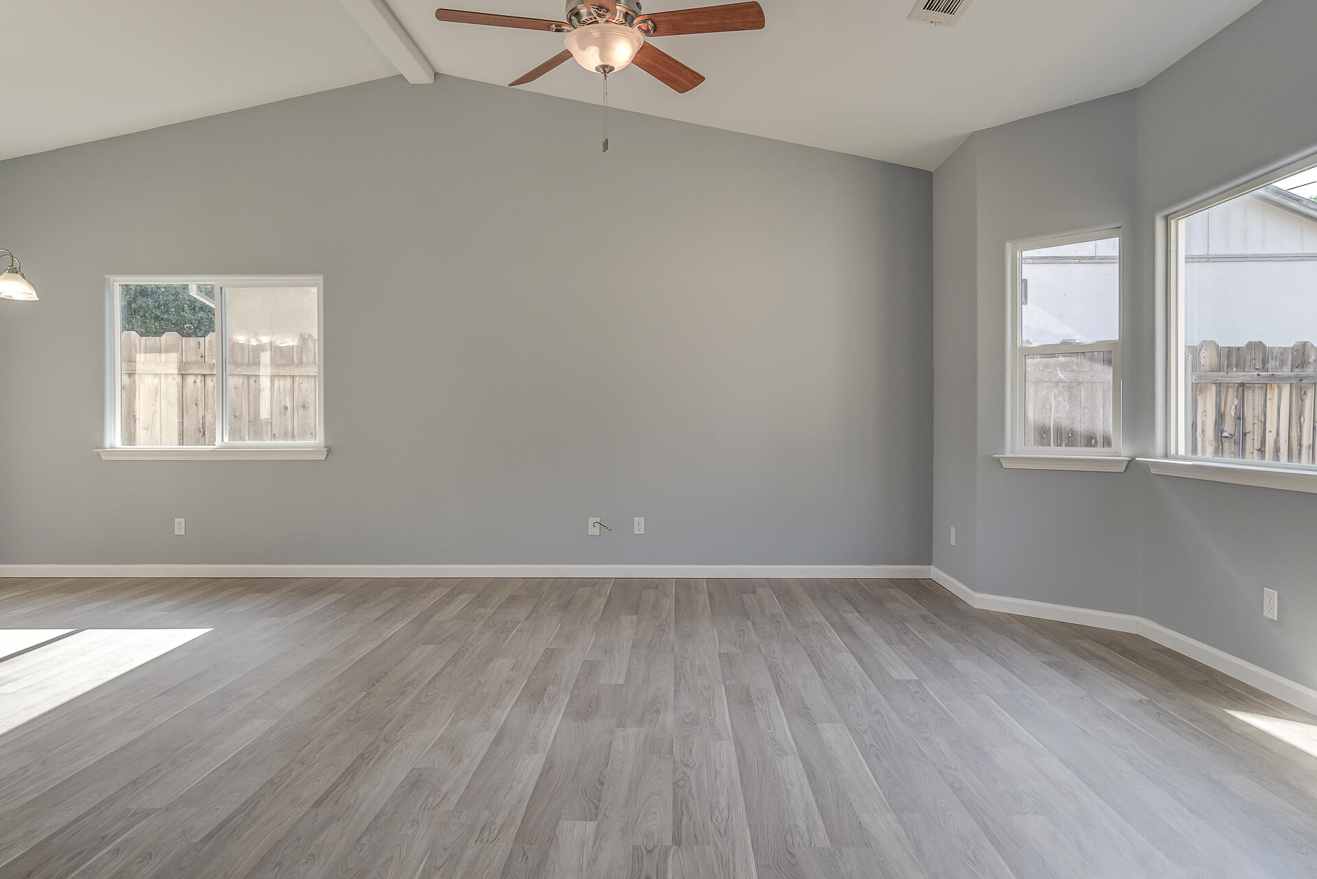 1101 Layton Road Redding, CA 96002 - Photo 3 of 37 an empty room with wooden floor and windows