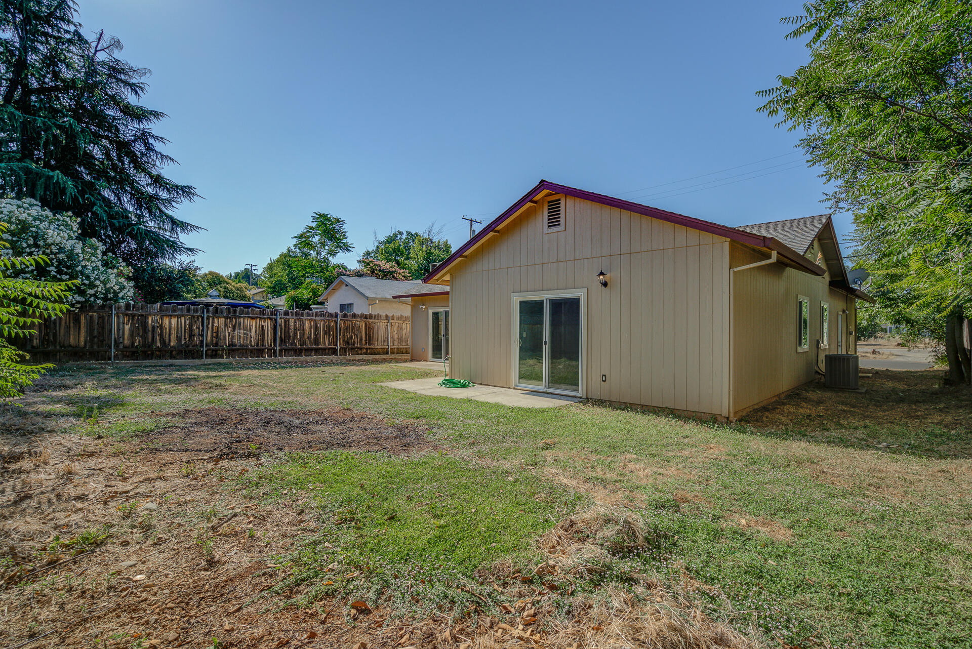 1101 Layton Road Redding, CA 96002 - Photo 32 of 37 a view of a house with backyard and a garden