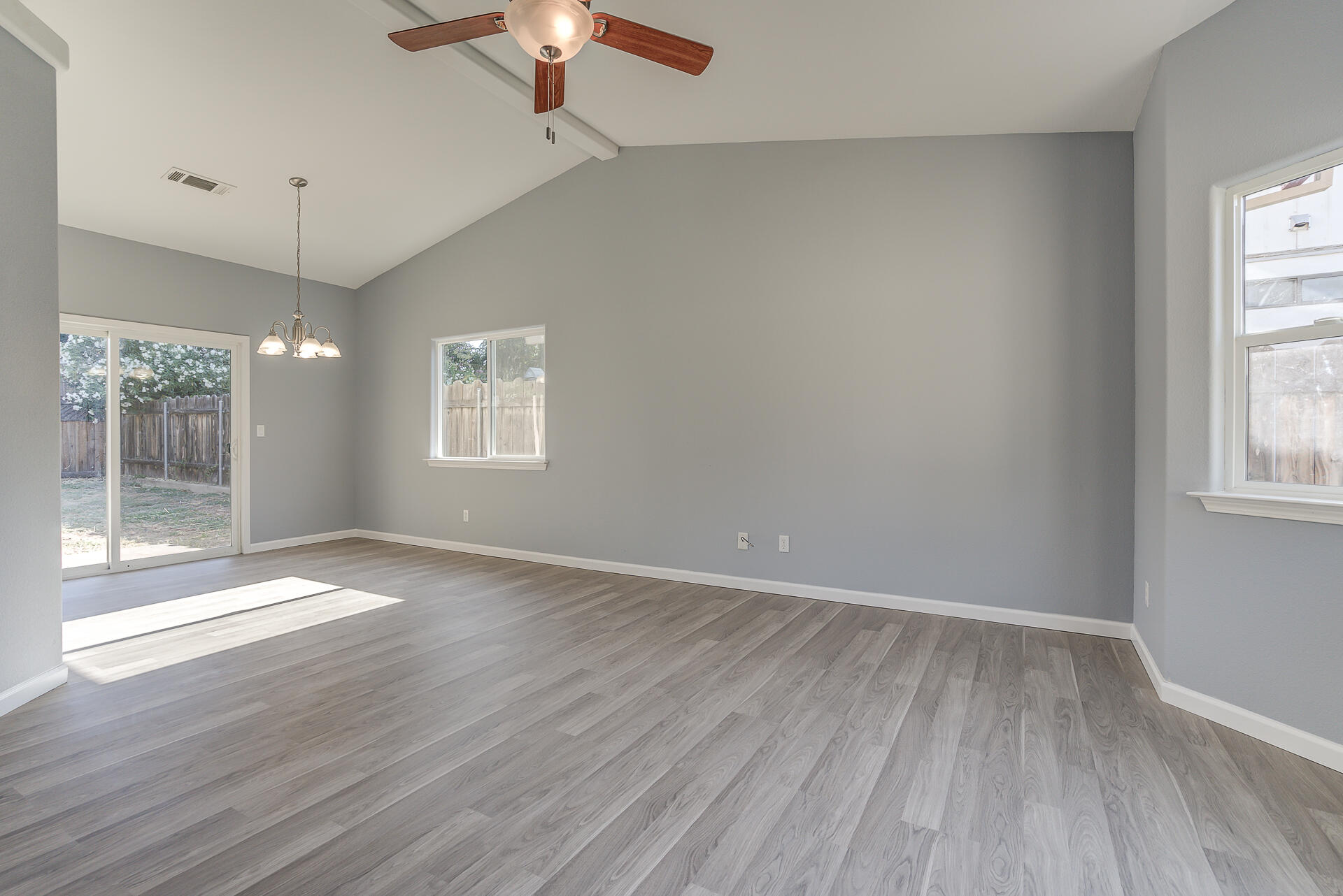 1101 Layton Road Redding, CA 96002 - Photo 4 of 37 an empty room with wooden floor and windows