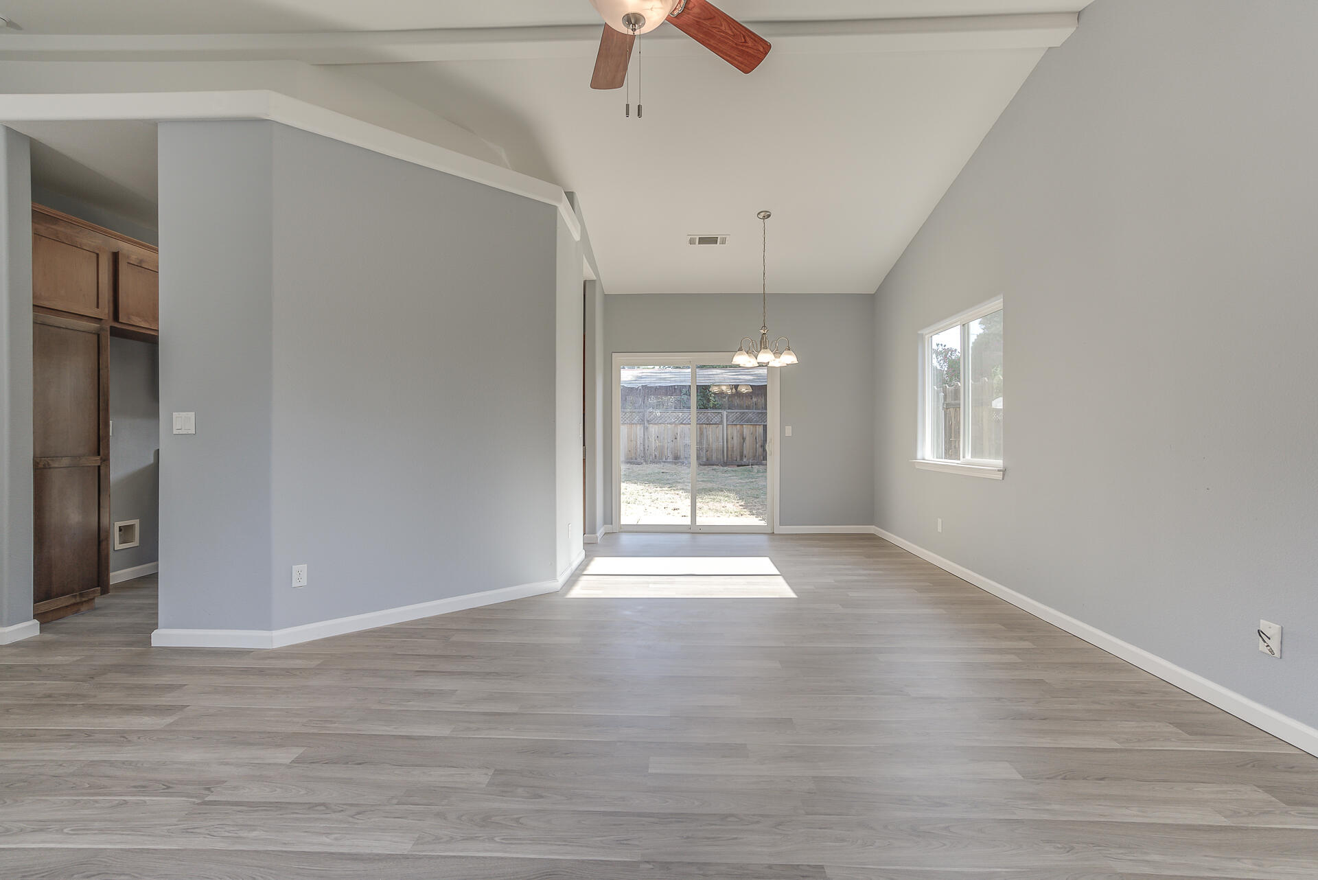 1101 Layton Road Redding, CA 96002 - Photo 5 of 37 a view of an empty room with window and wooden floor
