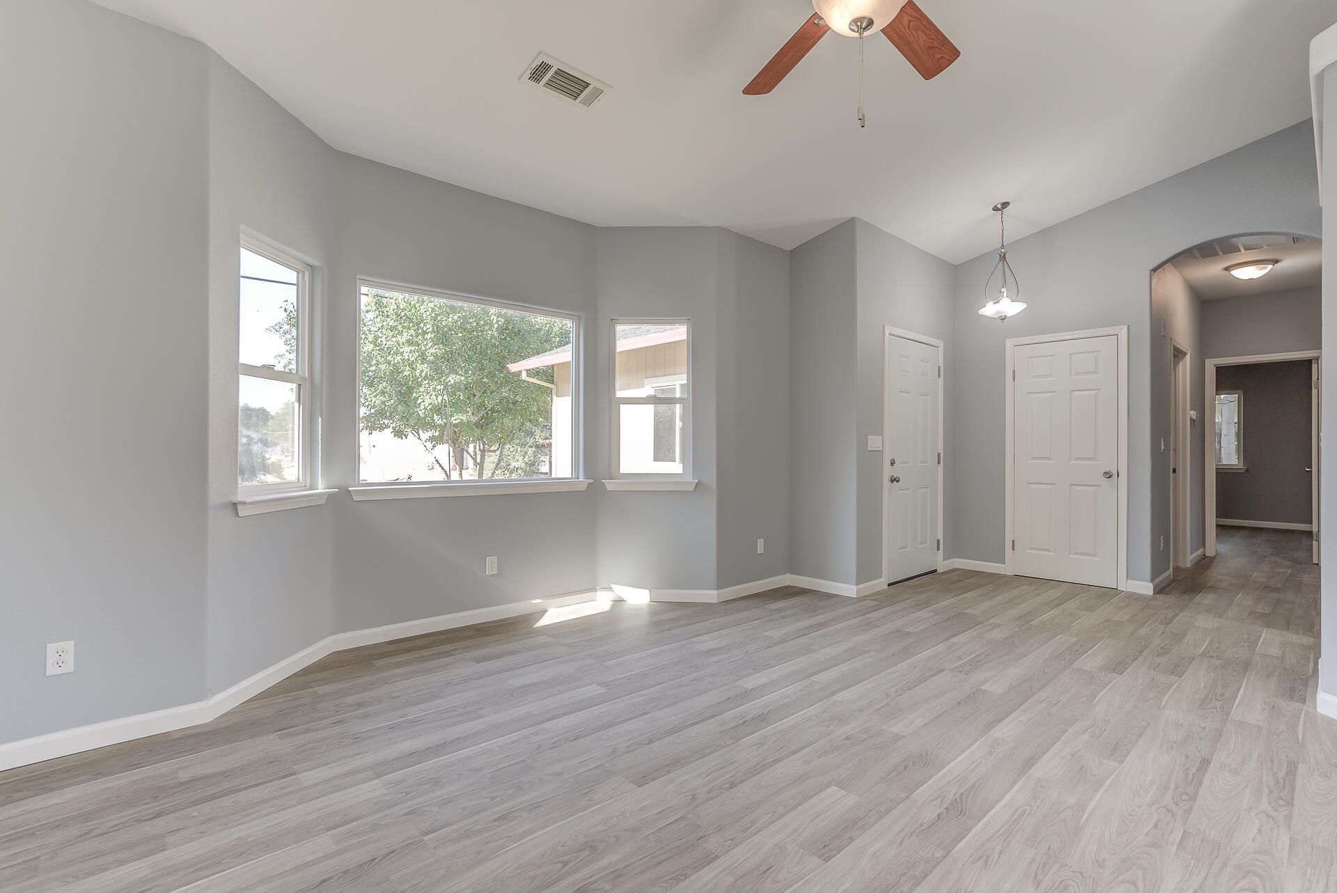 1101 Layton Road Redding, CA 96002 - Photo 7 of 37 a view of an empty room with window and wooden floor