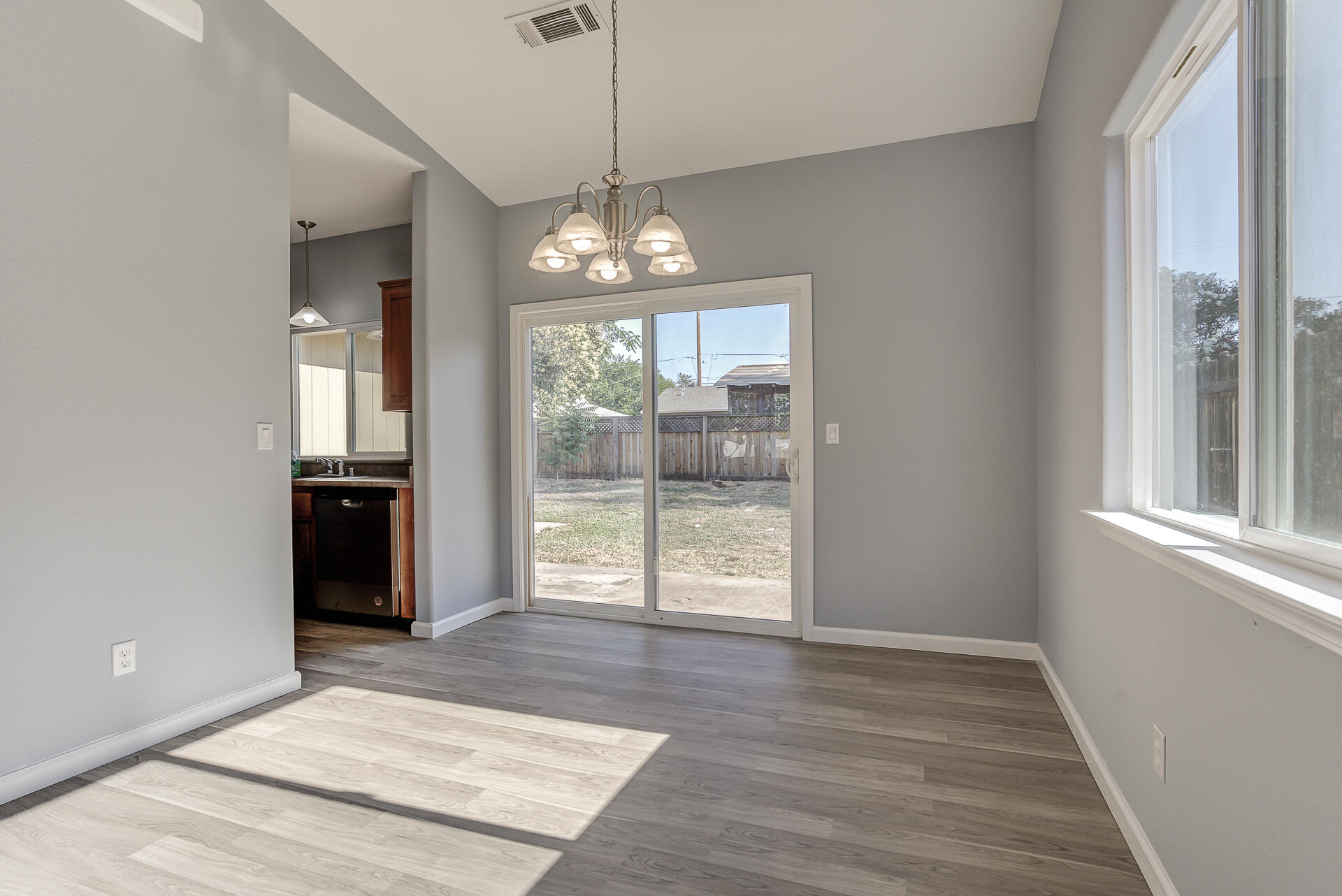 1101 Layton Road Redding, CA 96002 - Photo 8 of 37 a view of an empty room with wooden floor and a window