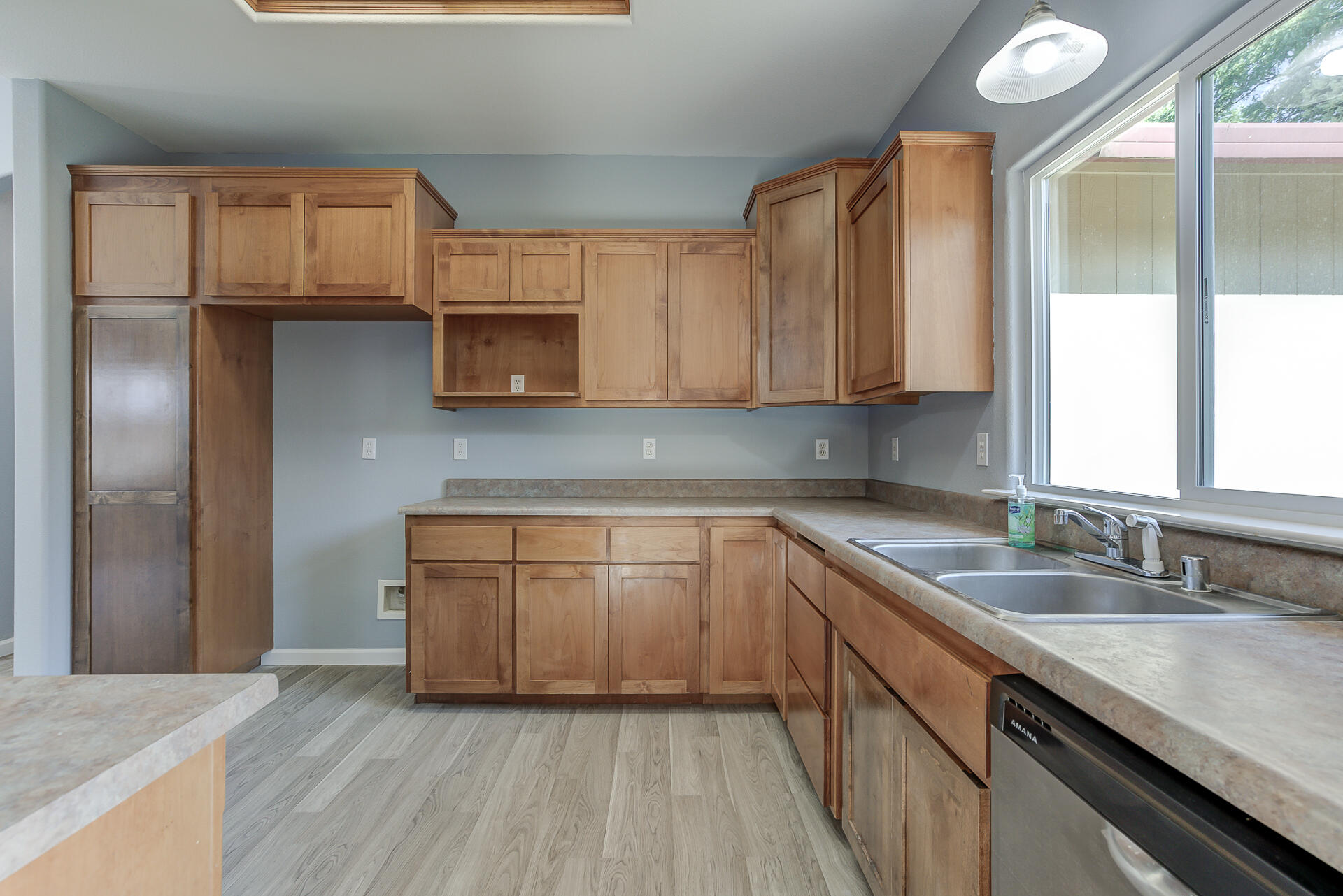 1101 Layton Road Redding, CA 96002 - Photo 10 of 37 a kitchen with granite countertop wooden cabinets and a sink