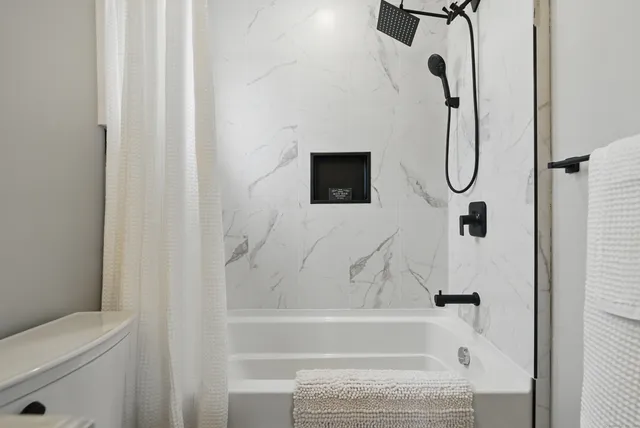 a bathroom with a bath tub and a shower