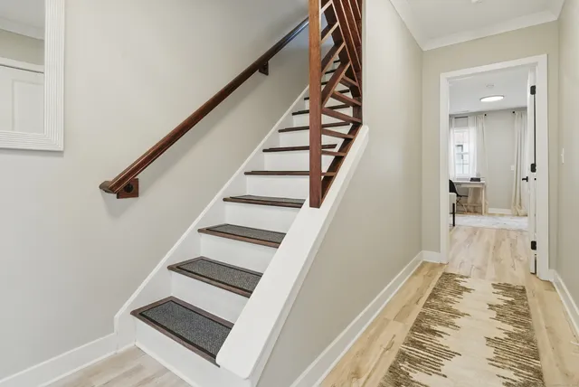 a view of a hallway with wooden floor and entryway