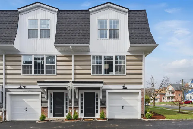 a front view of a residential apartment building with a yard