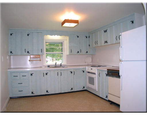 29 Norman Road Hamilton, MA 01982 - Photo 4 of 5 a kitchen with granite countertop white cabinets white appliances a sink and a window