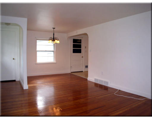 29 Norman Road Hamilton, MA 01982 - Photo 5 of 5 an empty room with wooden floor and windows