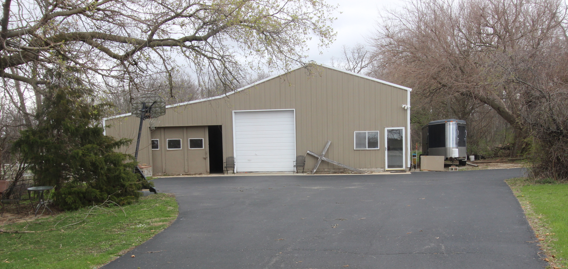 21614 River Road Marengo, IL 60152 - Photo 33 of 45 a front view of a house with a yard and garage