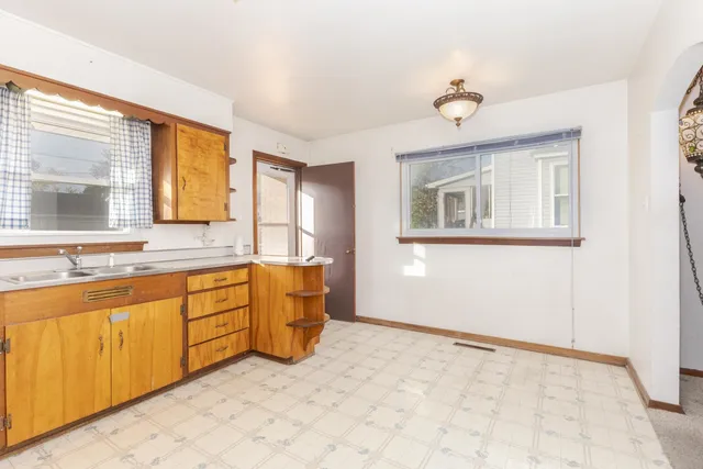 a spacious bathroom with a granite countertop sink mirror and a bathtub