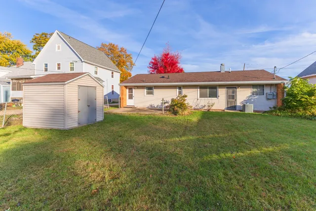 a front view of a house with a garden and plants