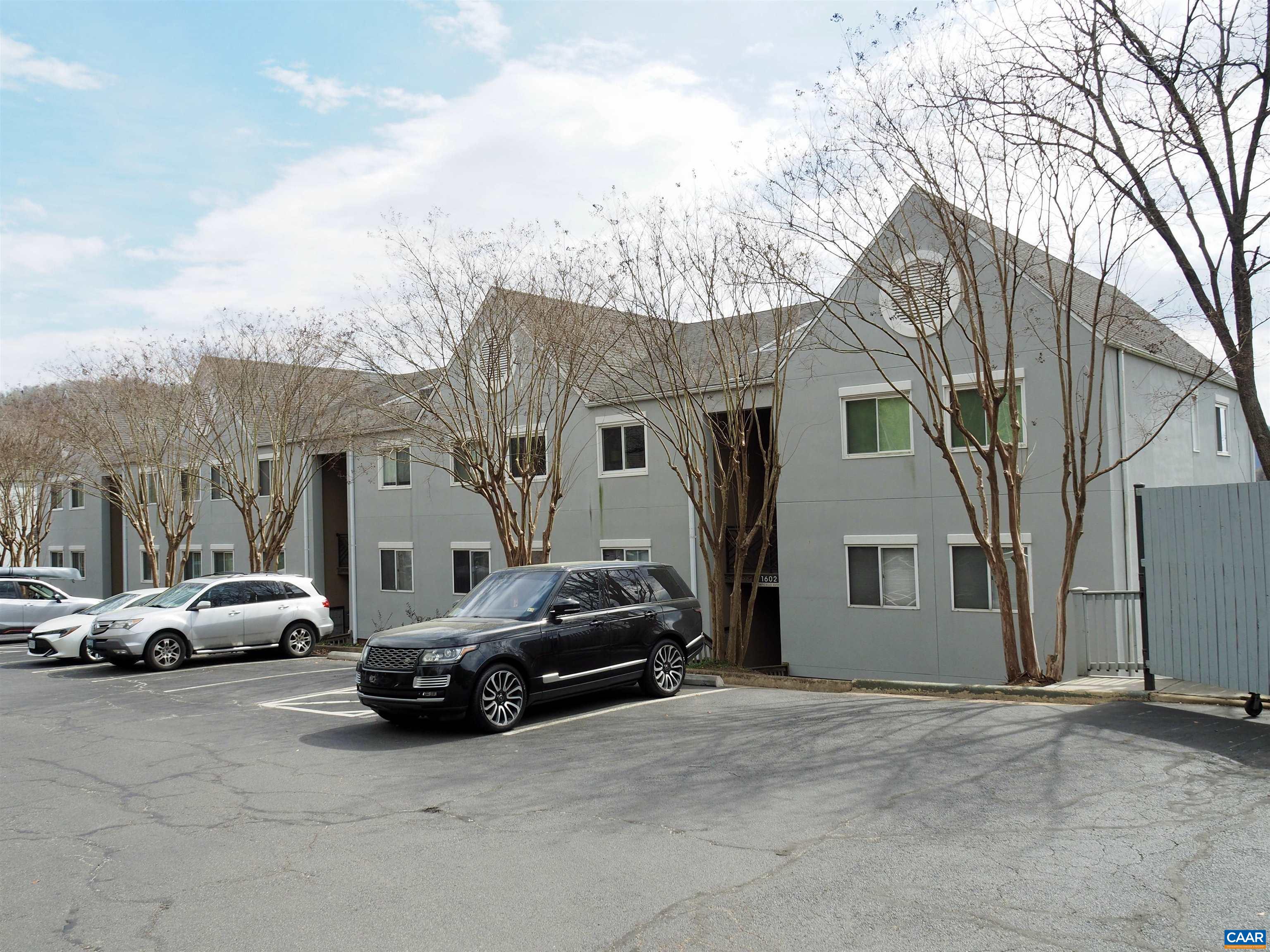a view of cars parked in front of a house