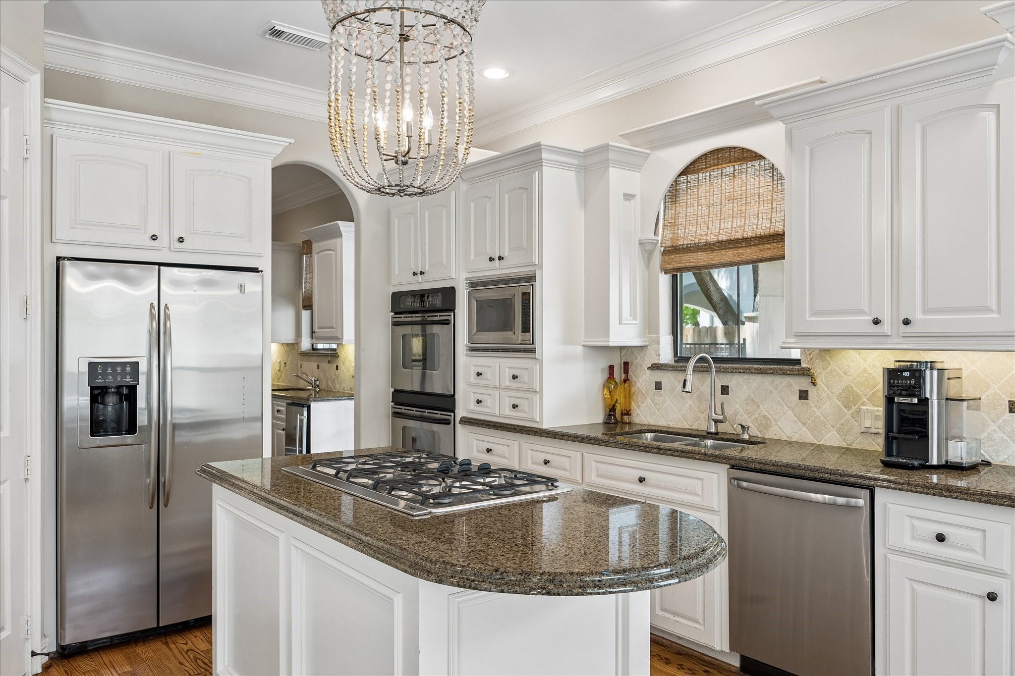 802 Anderson Street Bellaire, TX 77401 - Photo 14 of 36 The kitchen is light and bright with so much storage and a walk in pantry. The island cooktop allows for conversation while cooking.