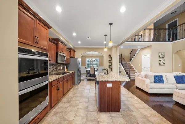 a large kitchen with stainless steel appliances kitchen island granite countertop a large counter top stainless steel appliances and cabinets