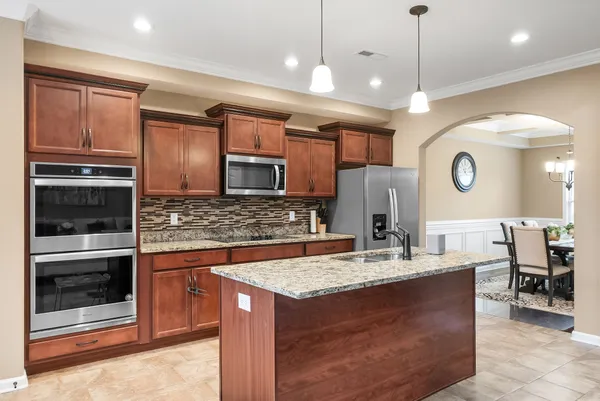 a kitchen with kitchen island granite countertop a sink and center island