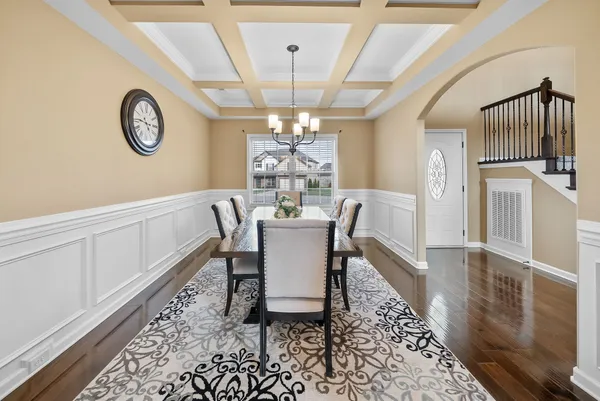 a view of a dining room with furniture and a chandelier