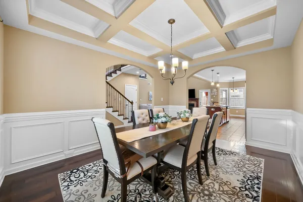 a spacious bedroom with a bed and a chandelier