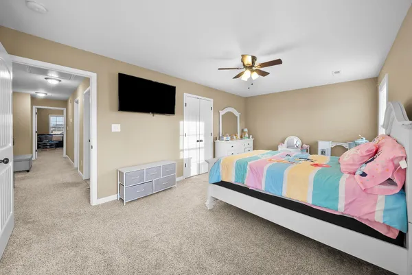 a bedroom with a bed and a dresser