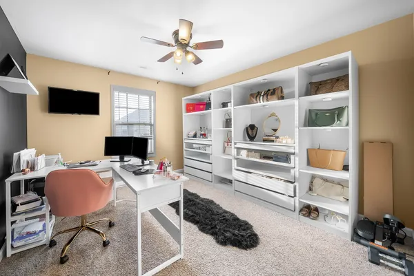 a work room with furniture and a flat screen tv