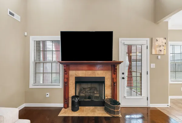 a living room with fireplace and a flat screen tv