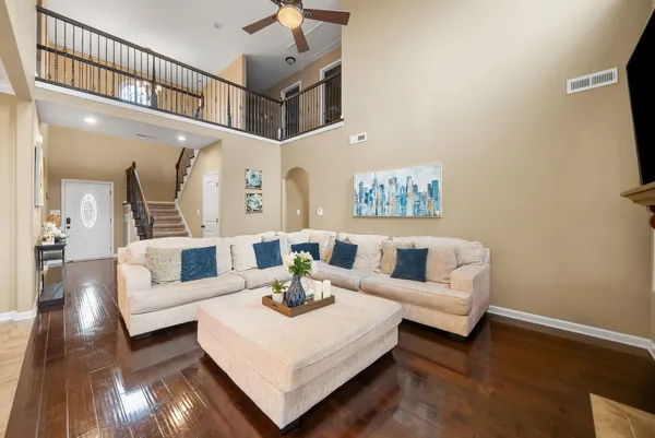 a living room with furniture and a wooden floor