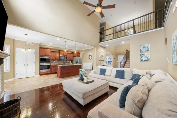 a living room with furniture and kitchen view