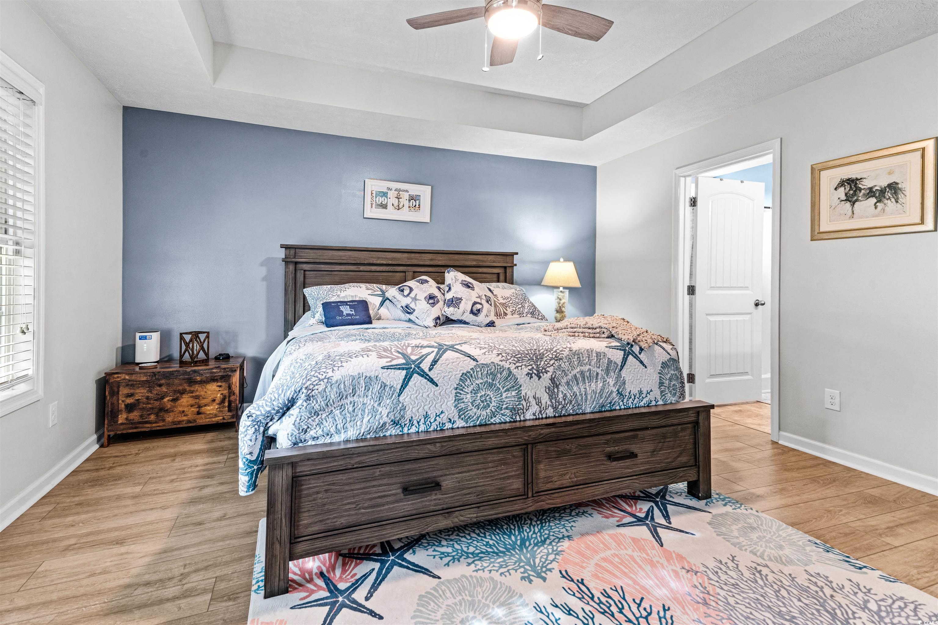 283 Beulah Circle Conway, SC 29527 - Photo 14 of 32 Bedroom with a tray ceiling, light wood-style floors, and ceiling fan