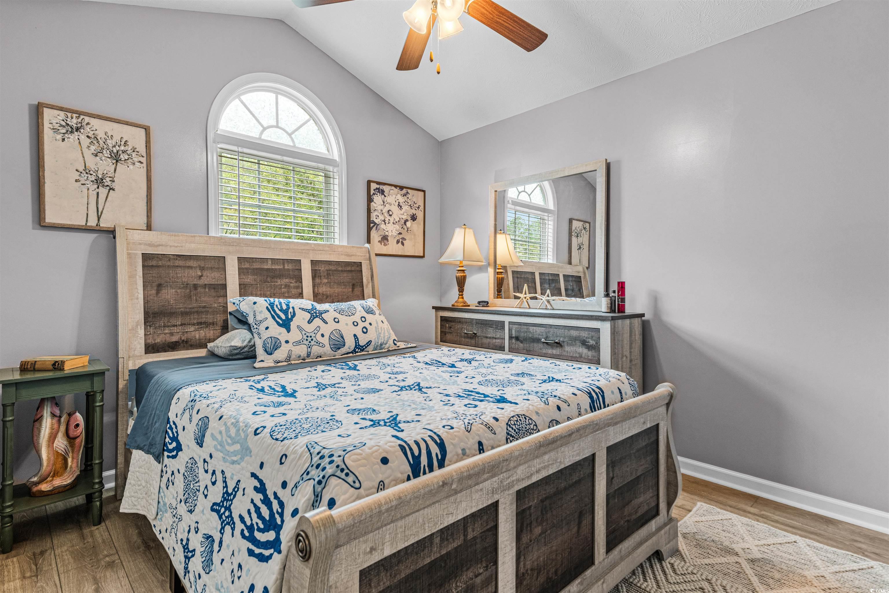 283 Beulah Circle Conway, SC 29527 - Photo 19 of 32 Bedroom featuring vaulted ceiling, wood finished floors, and a ceiling fan