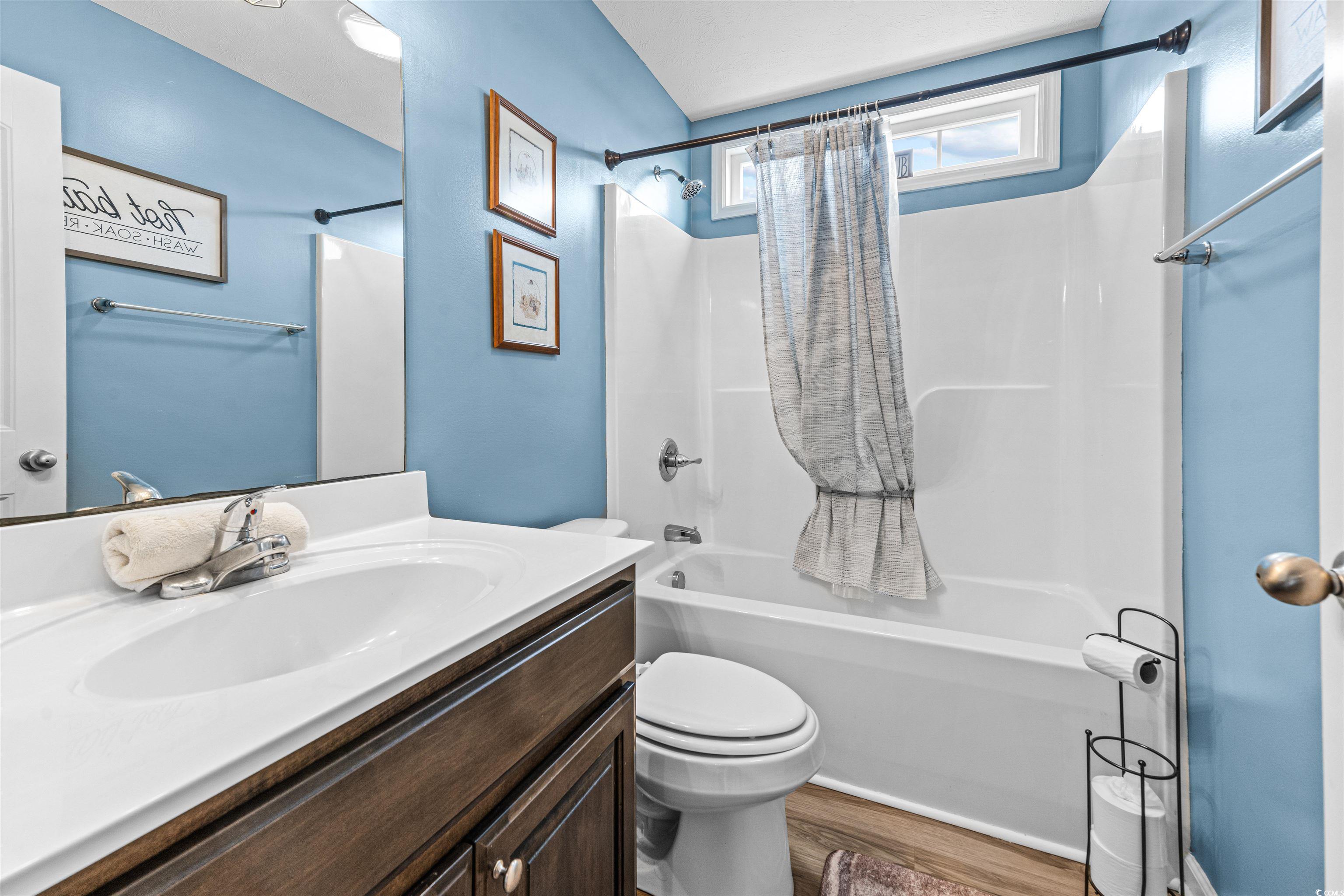 283 Beulah Circle Conway, SC 29527 - Photo 23 of 32 Bathroom with shower / bath combo with shower curtain, vanity, and dark wood finished floors