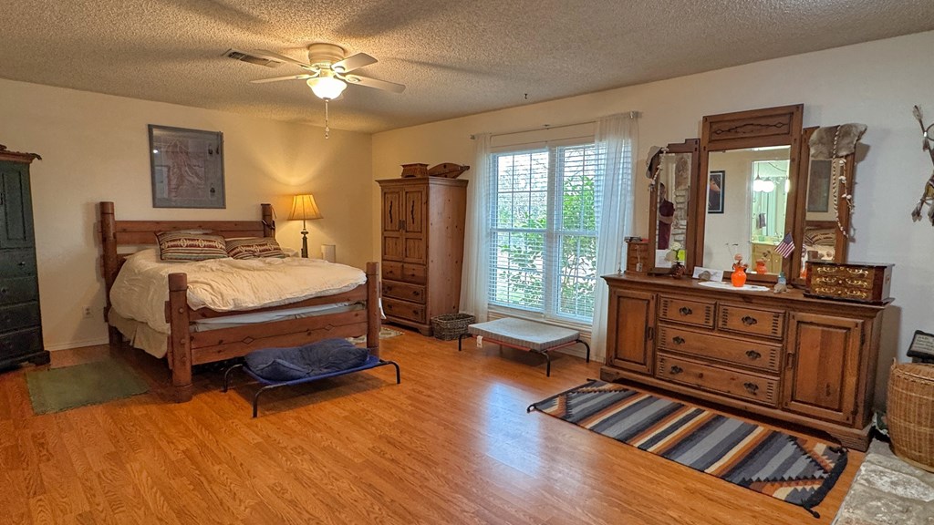 305 Rock Ridge Kerrville, TX 78028 - Photo 11 of 36 a bedroom with furniture and wooden floor
