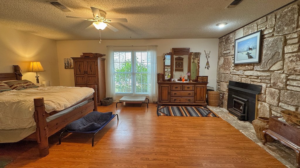 305 Rock Ridge Kerrville, TX 78028 - Photo 12 of 36 a bedroom with a bed and wooden floor