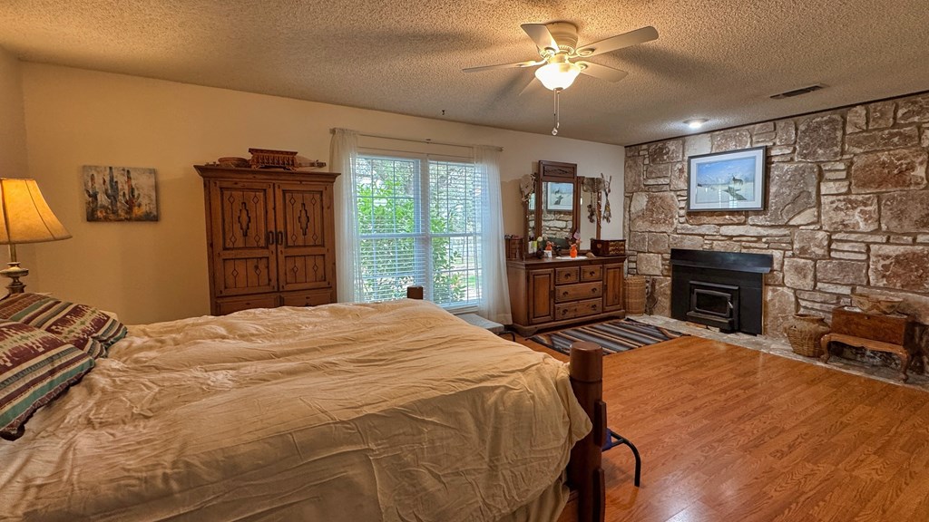 305 Rock Ridge Kerrville, TX 78028 - Photo 13 of 36 a bedroom with a bed and a flat screen tv