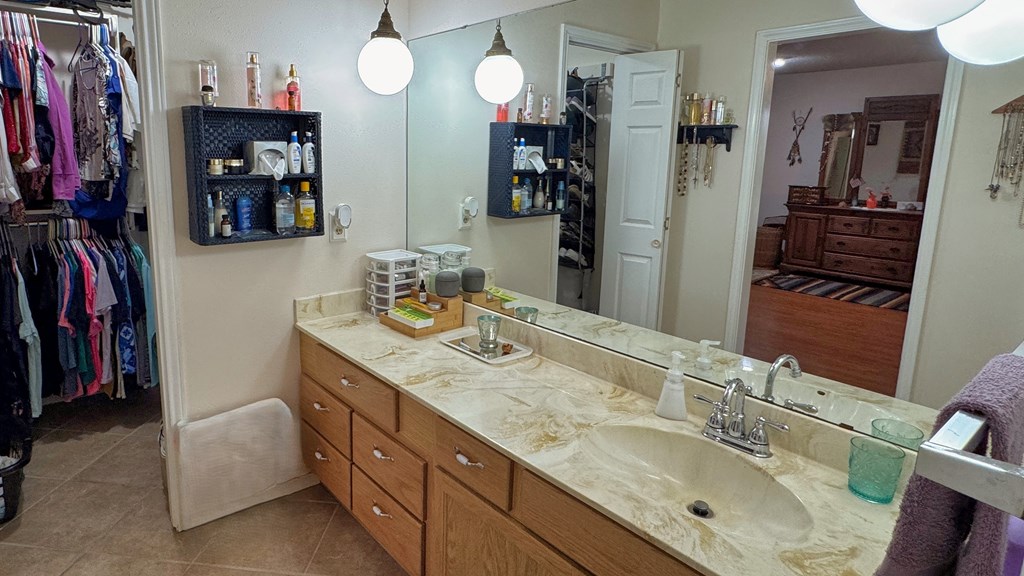 305 Rock Ridge Kerrville, TX 78028 - Photo 14 of 36 a bathroom with a double vanity sink and a mirror