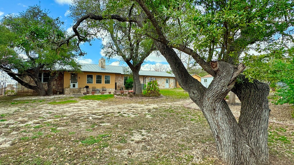 305 Rock Ridge Kerrville, TX 78028 - Photo 30 of 36 a front view of a house with a garden