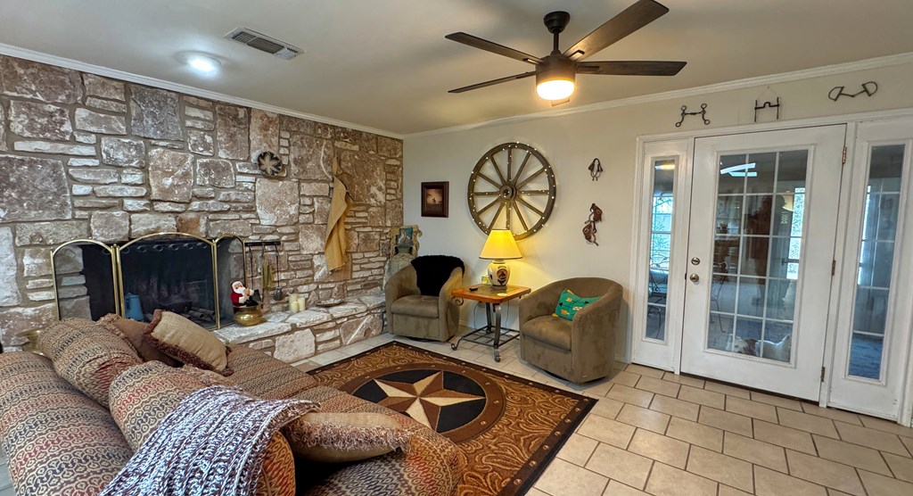 305 Rock Ridge Kerrville, TX 78028 - Photo 5 of 36 a living room with furniture a flat screen tv and a fireplace