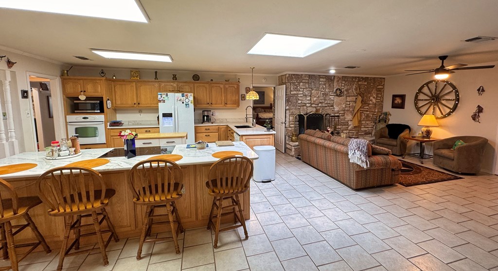 305 Rock Ridge Kerrville, TX 78028 - Photo 6 of 36 a very nice looking living room with a fireplace and a kitchen view