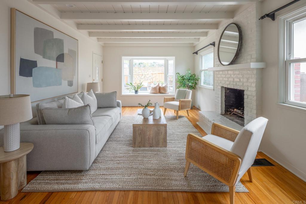 5416 Taft Avenue La Jolla, CA 92037 - Photo 1 of 23 a living room with furniture a fireplace and a large window